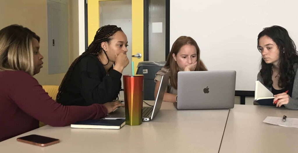 Community Techworkers discussing over computers