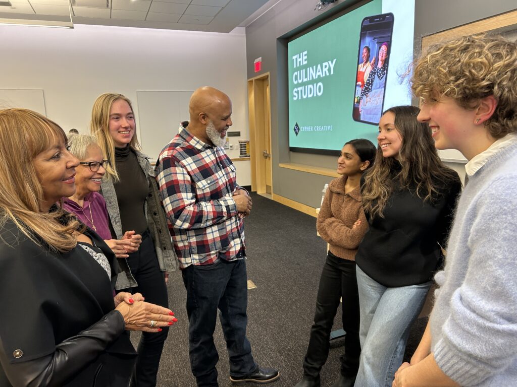 business owners (center) talk to their student team inside a ross school of business classroom